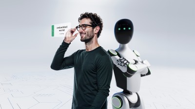 Man with smart glasses getting a call from embedded world and robot looking at you